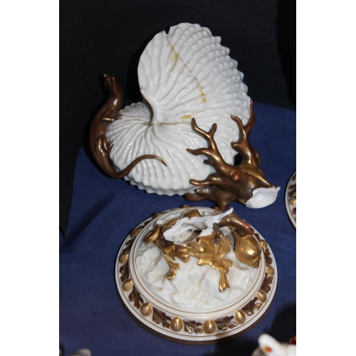 48 - Two Royal Worcester nautilus shell vases, one broken and restored, 22cm tall. (2)
