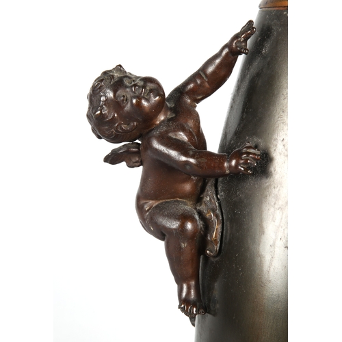 1 - Metal vase with climbing cherub handles, 37cm h.