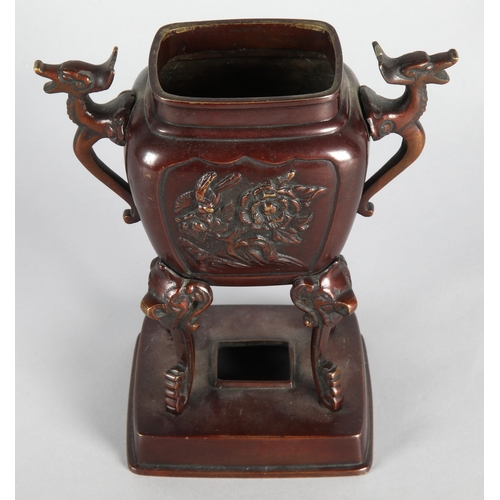 41 - Oriental raised bronzed censor with animal head motifs, 18cm h.