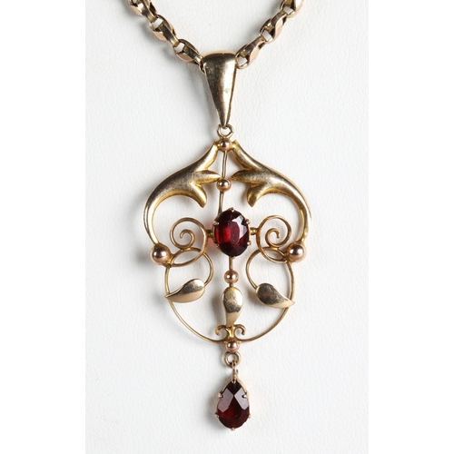 57 - 9ct gold garnet pendant on a 9ct gold chain, gross weight 8g.
