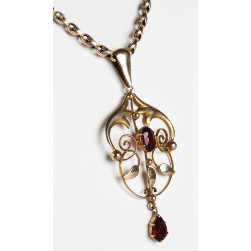 57 - 9ct gold garnet pendant on a 9ct gold chain, gross weight 8g.