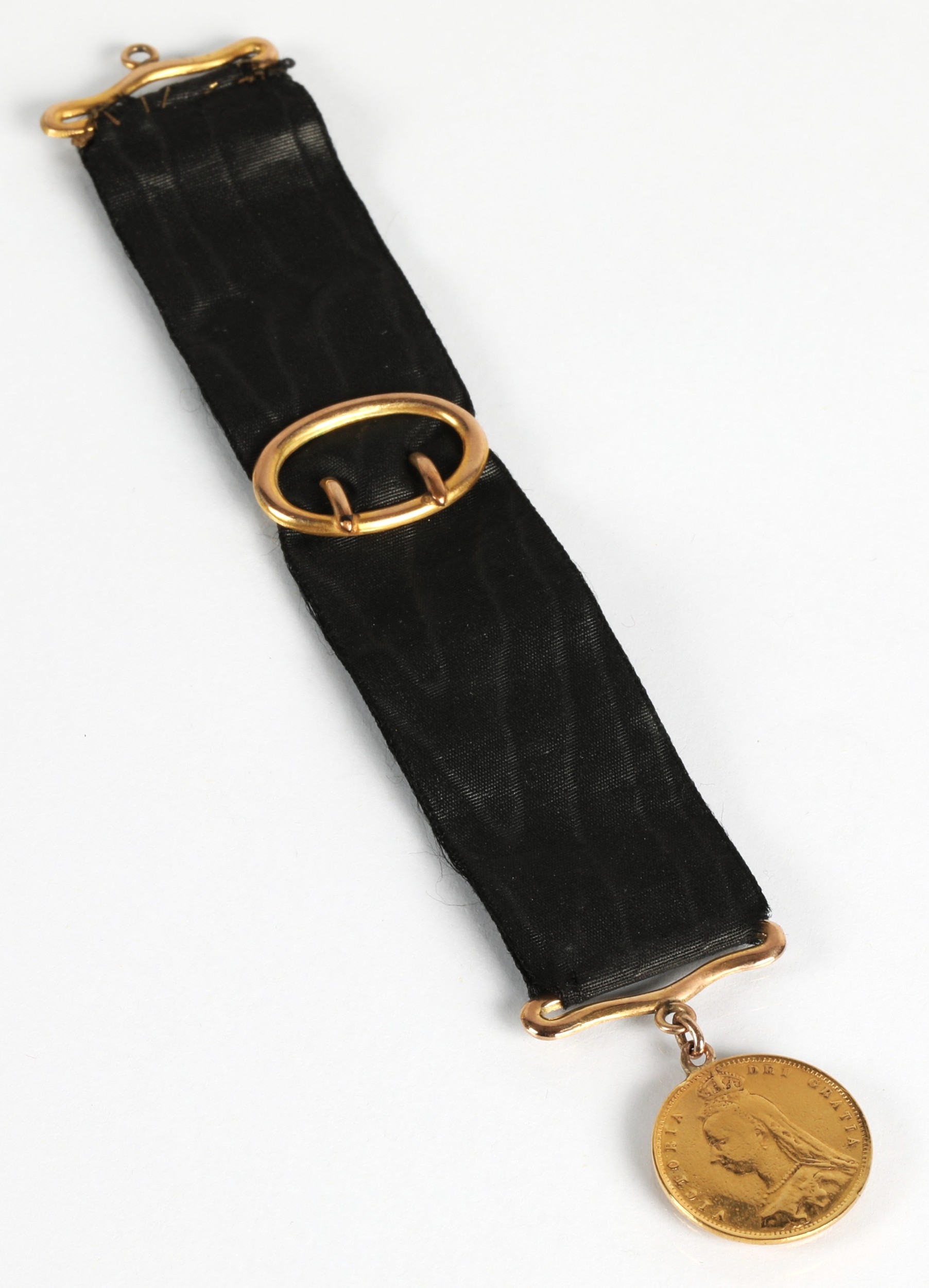 Victorian gold half sovereign 1892 mounted to a ribbon.