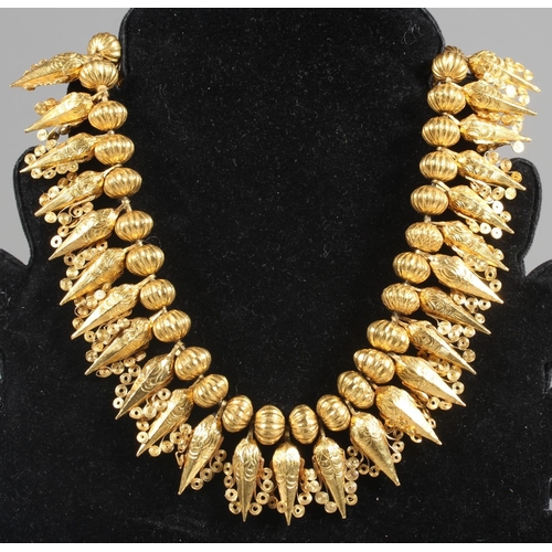 148 - Eastern high carat gold fringe collar formed of alternating pumpkin shaped and faceted cone drops wi... 