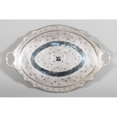 4 - Indian white metal twin handled tray with all over engraved floral decoration, 51cm long, 1061g.