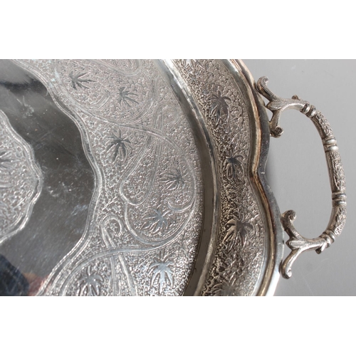 4 - Indian white metal twin handled tray with all over engraved floral decoration, 51cm long, 1061g.