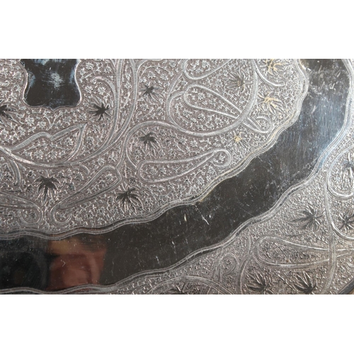 4 - Indian white metal twin handled tray with all over engraved floral decoration, 51cm long, 1061g.