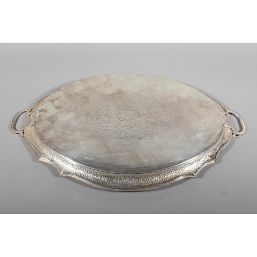 4 - Indian white metal twin handled tray with all over engraved floral decoration, 51cm long, 1061g.