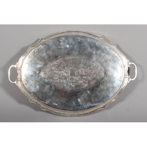 4 - Indian white metal twin handled tray with all over engraved floral decoration, 51cm long, 1061g.