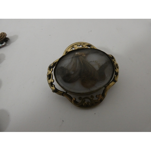 Victorian-style scroll mourning brooch containing a lock of hair ...