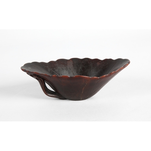 175 - 18th century Rhinoceros horn libation cup in the form of a lotus leaf. The cup has been split and re... 