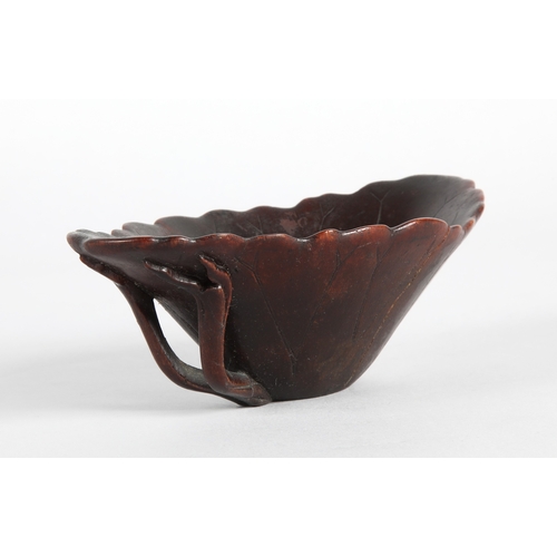 175 - 18th century Rhinoceros horn libation cup in the form of a lotus leaf. The cup has been split and re... 