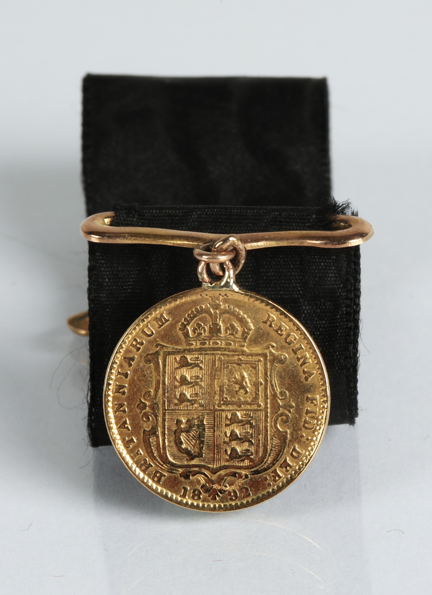 Victorian gold half sovereign 1892 mounted to a ribbon.