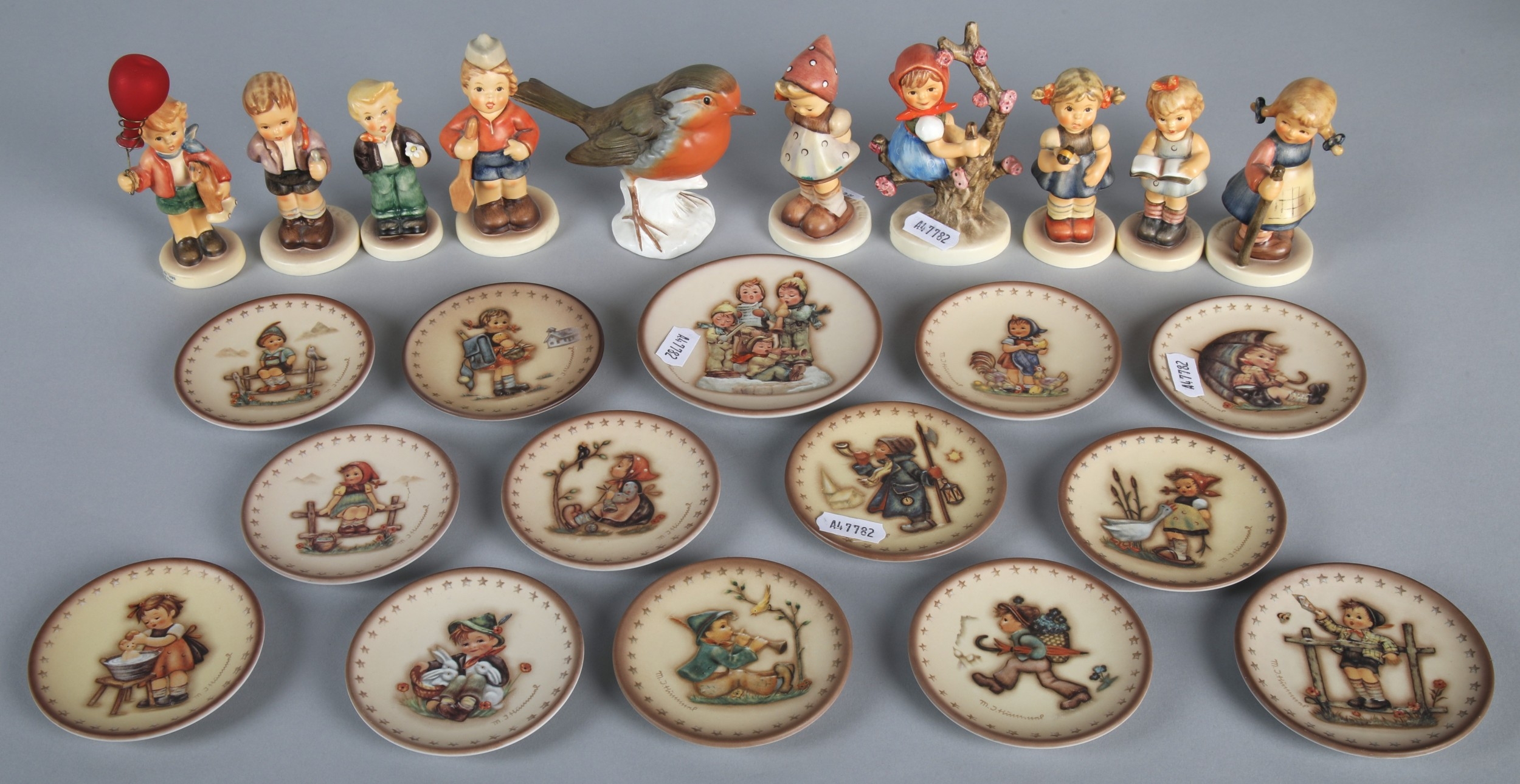 Collection of Goebel Hummel pin dishes and display rack with ten Hummel ...