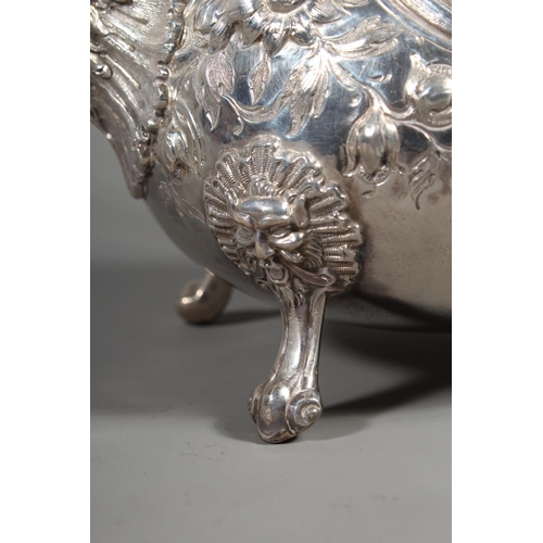 82 - Victorian silver four piece tea service having all over repousse floral, Rococo scroll and green man... 