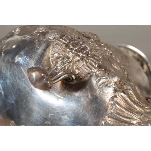82 - Victorian silver four piece tea service having all over repousse floral, Rococo scroll and green man... 