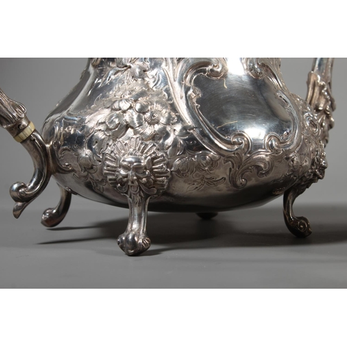 82 - Victorian silver four piece tea service having all over repousse floral, Rococo scroll and green man... 