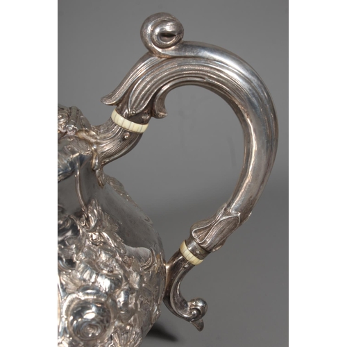 82 - Victorian silver four piece tea service having all over repousse floral, Rococo scroll and green man... 
