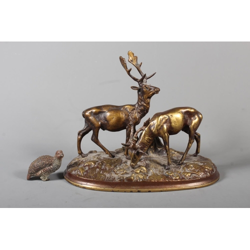 255 - Gilt metal cast figure of two stags and a cold painted bronze of a grouse.&nbsp; (2)