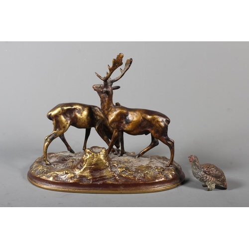 255 - Gilt metal cast figure of two stags and a cold painted bronze of a grouse.&nbsp; (2)