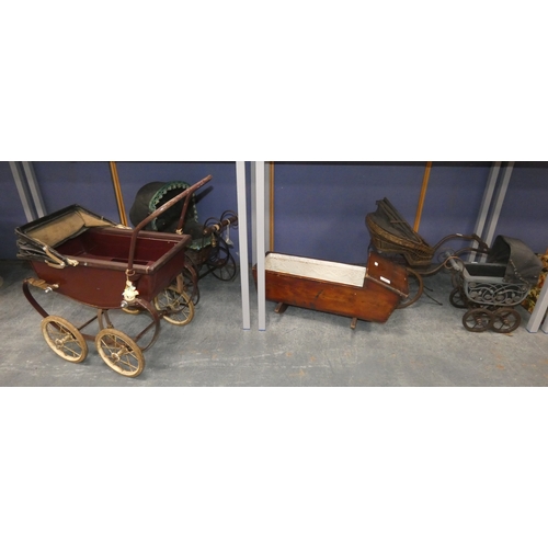 107 - Four dolls prams and a pine dolls cradle with contents.