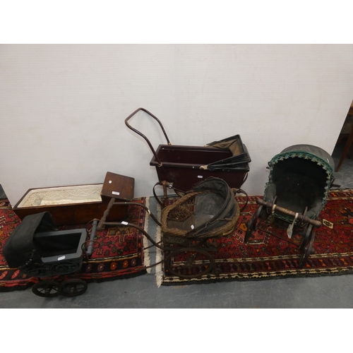 107 - Four dolls prams and a pine dolls cradle with contents.