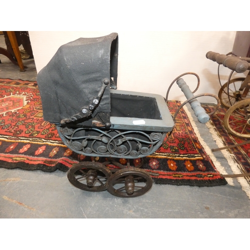 107 - Four dolls prams and a pine dolls cradle with contents.