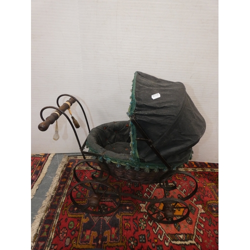 107 - Four dolls prams and a pine dolls cradle with contents.