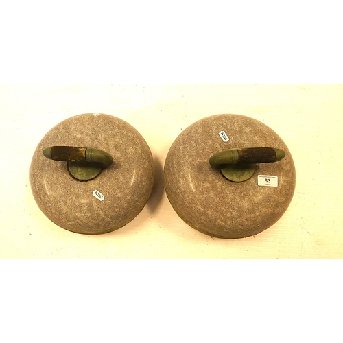 83 - Pair of granite curing stones with handles.