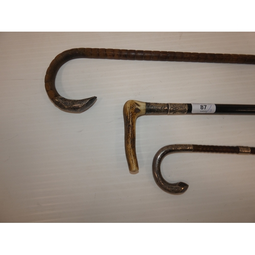 87 - Two Edwardian silver mounted walking sticks, to include an ebonised example with antler grip, and an... 