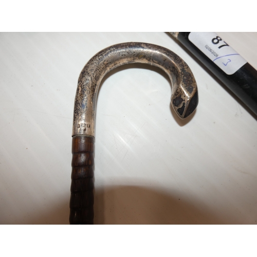87 - Two Edwardian silver mounted walking sticks, to include an ebonised example with antler grip, and an... 