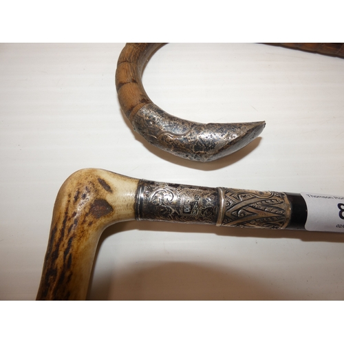 87 - Two Edwardian silver mounted walking sticks, to include an ebonised example with antler grip, and an... 