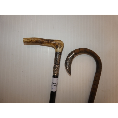 87 - Two Edwardian silver mounted walking sticks, to include an ebonised example with antler grip, and an... 