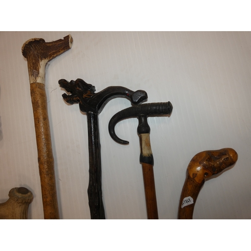 90 - Group of walking sticks to include an example with an antler grip and another with a pheasant head.