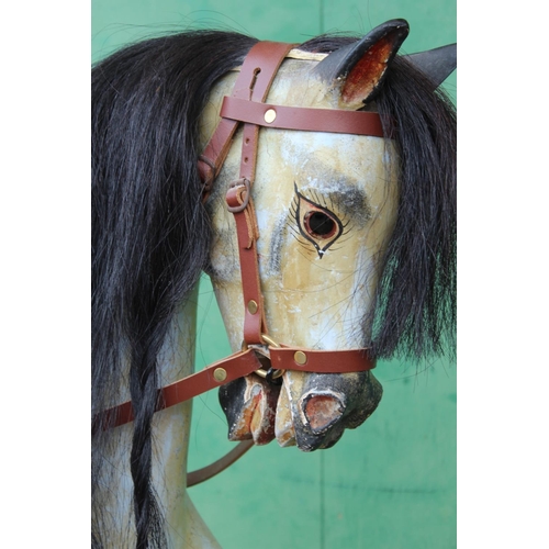 455 - 19th century rocking horse with horse hair mane and tail, leather tack, raised on crossoform cradle,... 