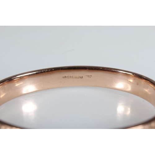 9ct gold snap shut bangle with half engraved sinuous scrolling foliate ...