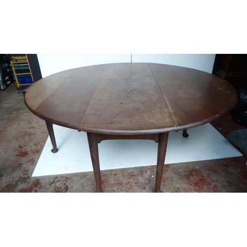 497 - George III mahogany drop flap wake or dining table on turned supports and pad feet, 189cm wide.