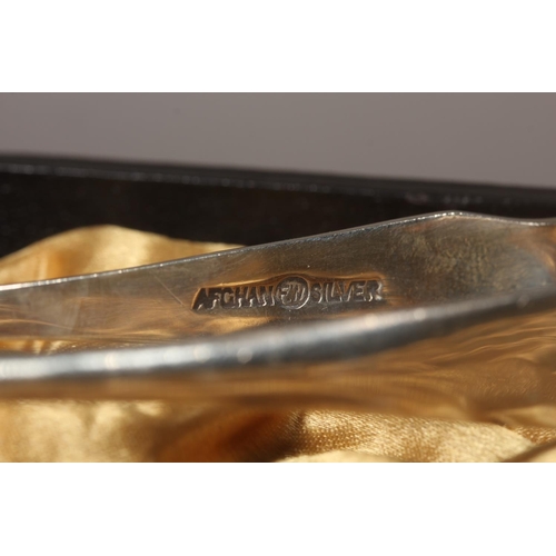 13 - Cased set of silver plated spoons and tongs.