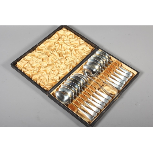 13 - Cased set of silver plated spoons and tongs.
