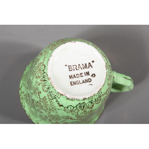 22 - Brama Mid Winter green and gold pattern six piece and biscuit barrel set.