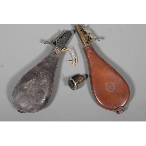 26 - Two antique leather shot flask with brass fittings.