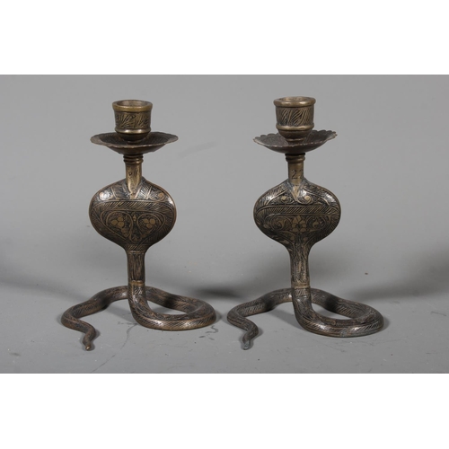 34 - Pair of brass cobra candlestick holders.