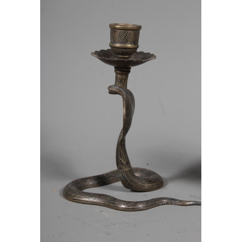 34 - Pair of brass cobra candlestick holders.