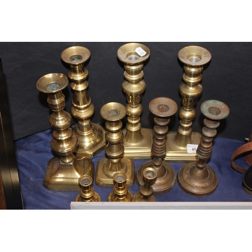 45 - Brass candlesticks in various sizes.