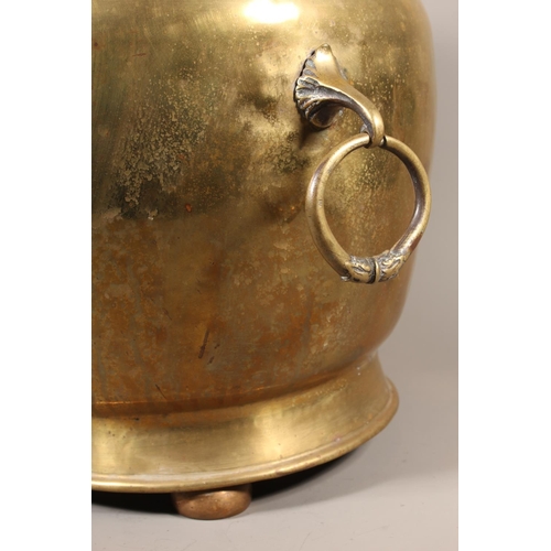 7 - Large brass jardini&egrave;re with twin handles and embossed floral front and topped finial, 50cm ta... 