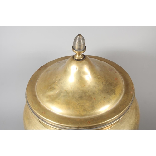 7 - Large brass jardini&egrave;re with twin handles and embossed floral front and topped finial, 50cm ta... 