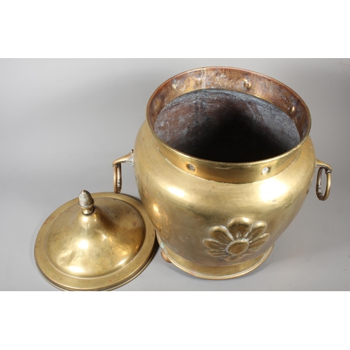 7 - Large brass jardini&egrave;re with twin handles and embossed floral front and topped finial, 50cm ta... 