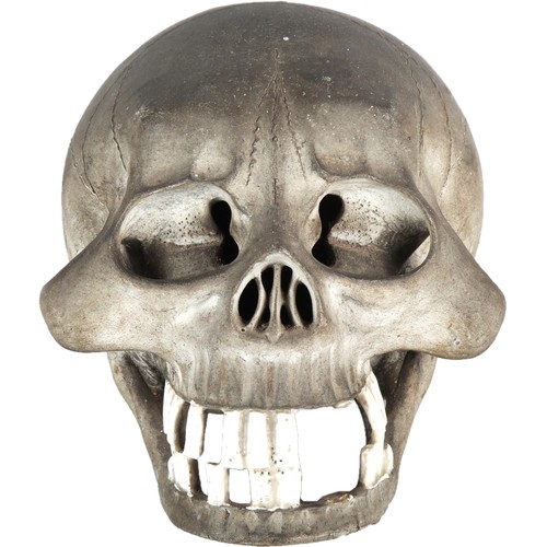 Charcoal grey pottery stylised skull, featuring prominent cheekbones and block teeth, unmarked. Height 13.2cm.