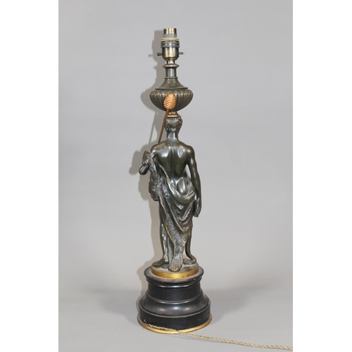 12 - French early 20th century bronzed metal table lamp in the form of a Roman figure holding pan pipes a... 