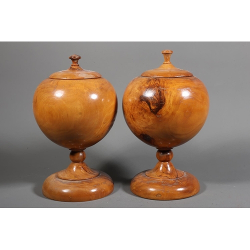 28 - Pair of olive wood turned baluster vases with lids, 21cm high.