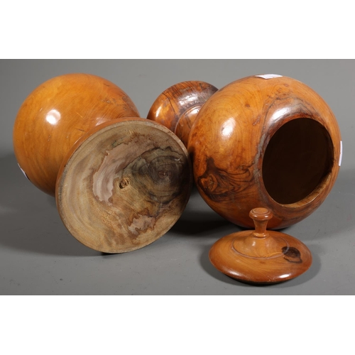 28 - Pair of olive wood turned baluster vases with lids, 21cm high.